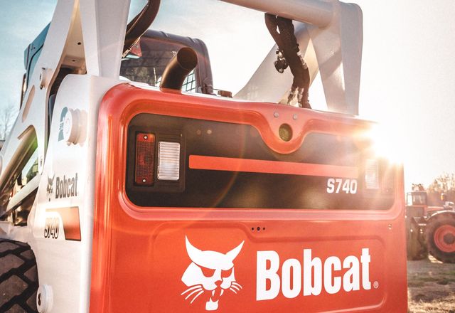 Skid steer loader on a dirt work site